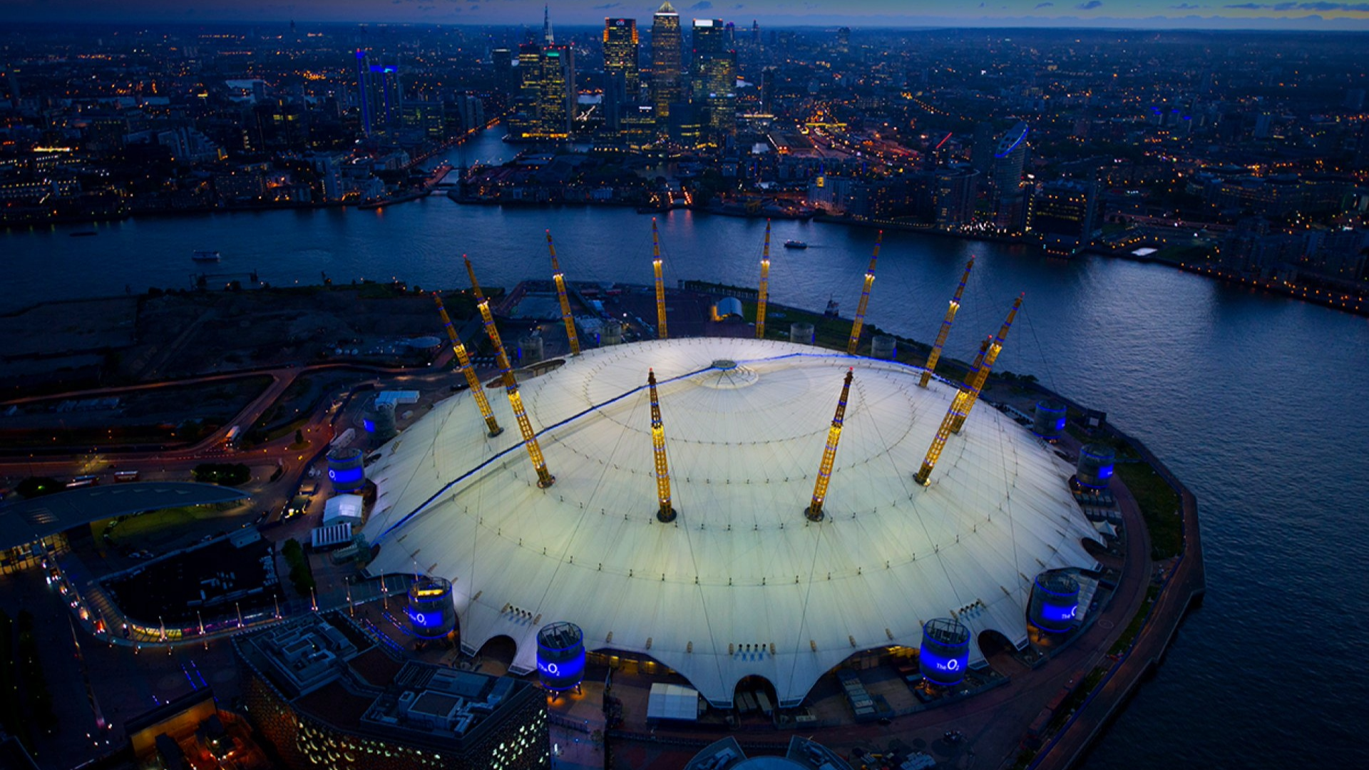 Editorial graphic featuring an aerial view of London's The O2, announcing AEG and O2's naming-rights renewal through 2038.